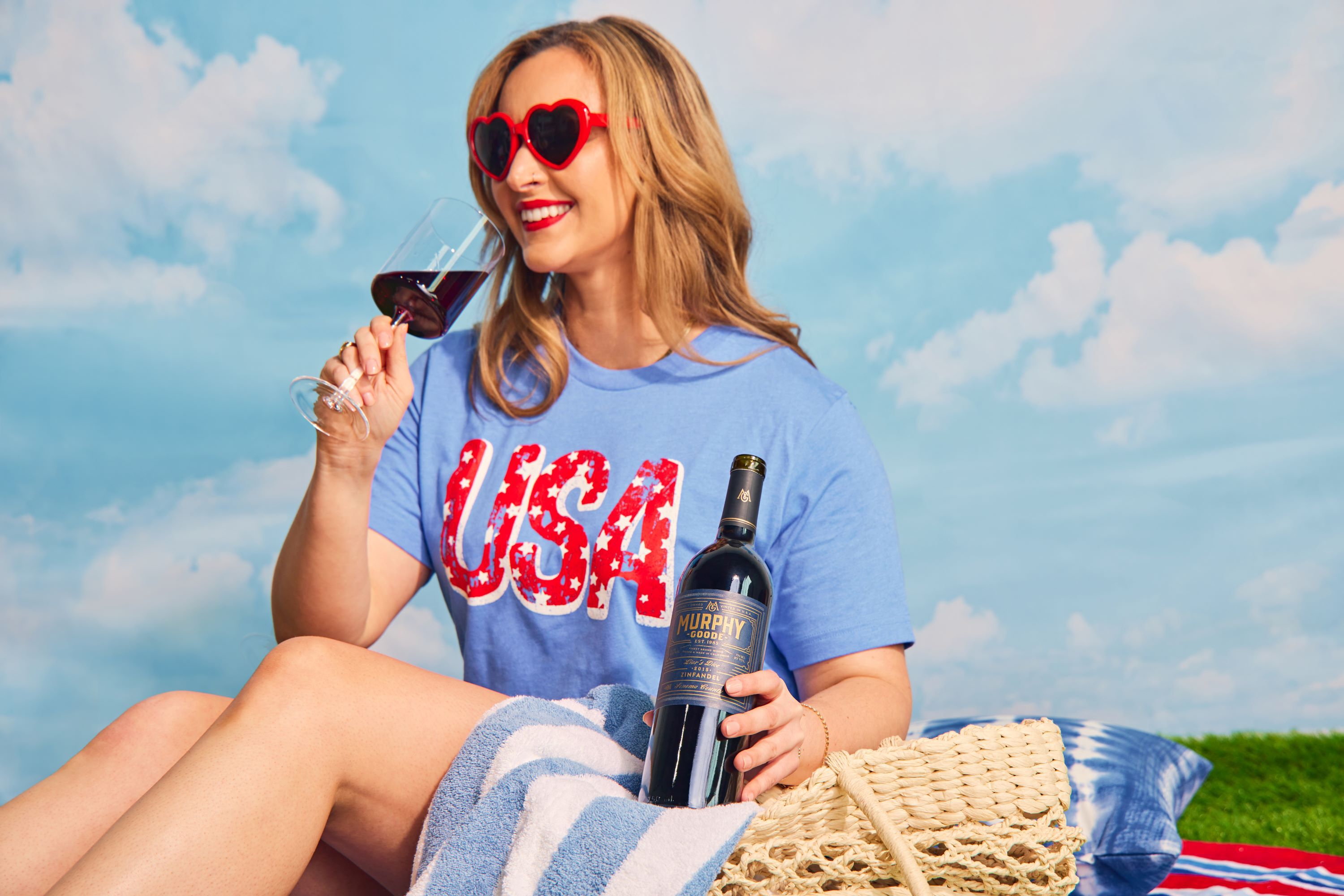 Woman sitting poolside with wine in bucket on ice